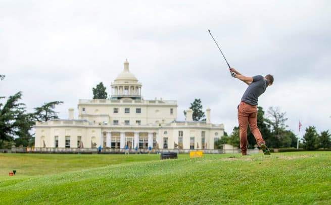 Man hitting a golf ball outside Stoke park gold club | Kelly Chandler Consulting