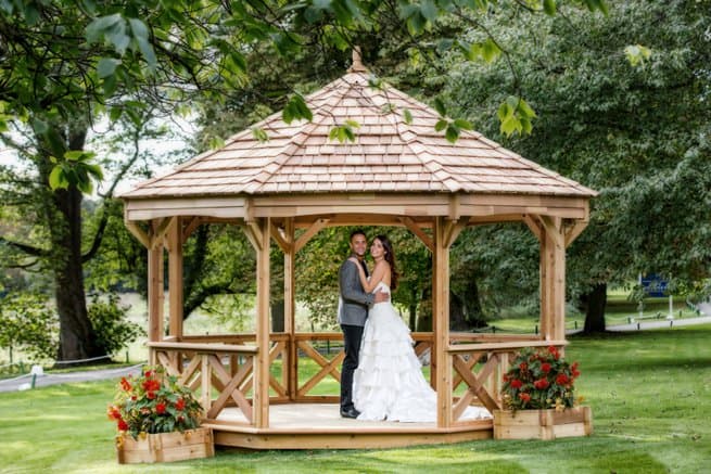 Bride and groom under a gazebo | Kelly Chandler Consulting