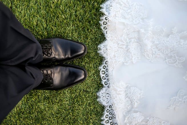 Looking down at a bride and grooms shoes | Kelly Chandler Consulting