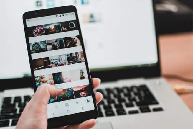 Lady holding iphone looking at photos | Kelly Chandler Constuling