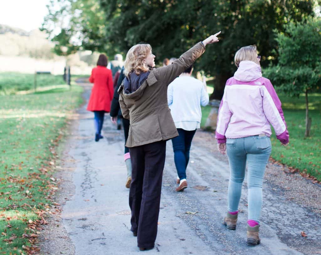 Woman on a leisurely walk pointing at Warmwell House 