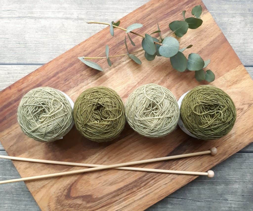 Four green balls of wool