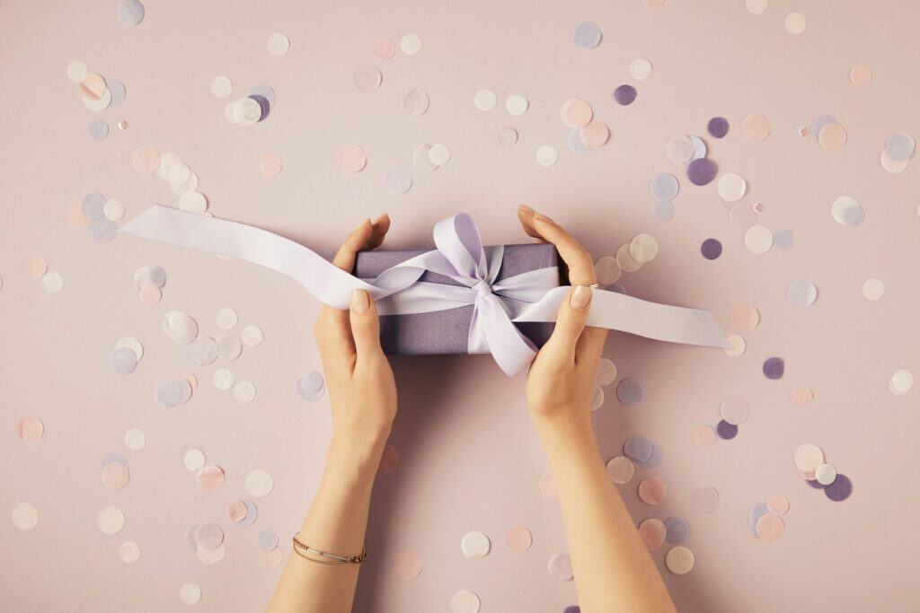 woman holding gift to secure more wedding bookings