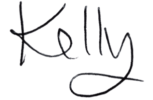 Kelly Chandler's signature in black chalk on a dark background.