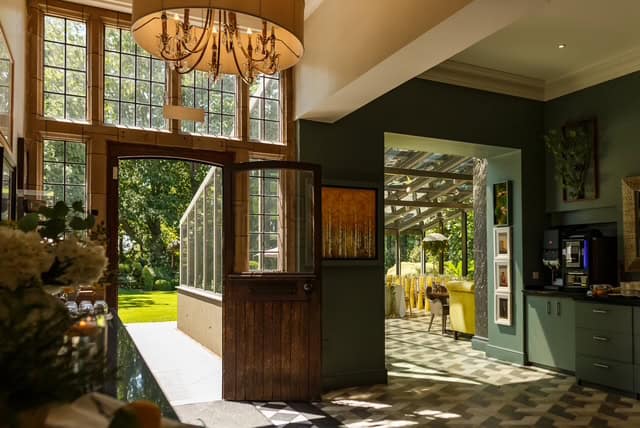 Bright kitchen with large windows and a view of the garden outside.