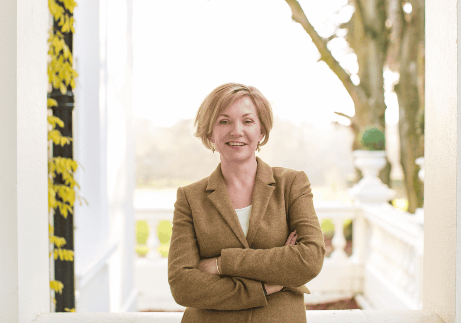 Woman wearing tweed jacket with arm folded Kelly Chandler Consulting