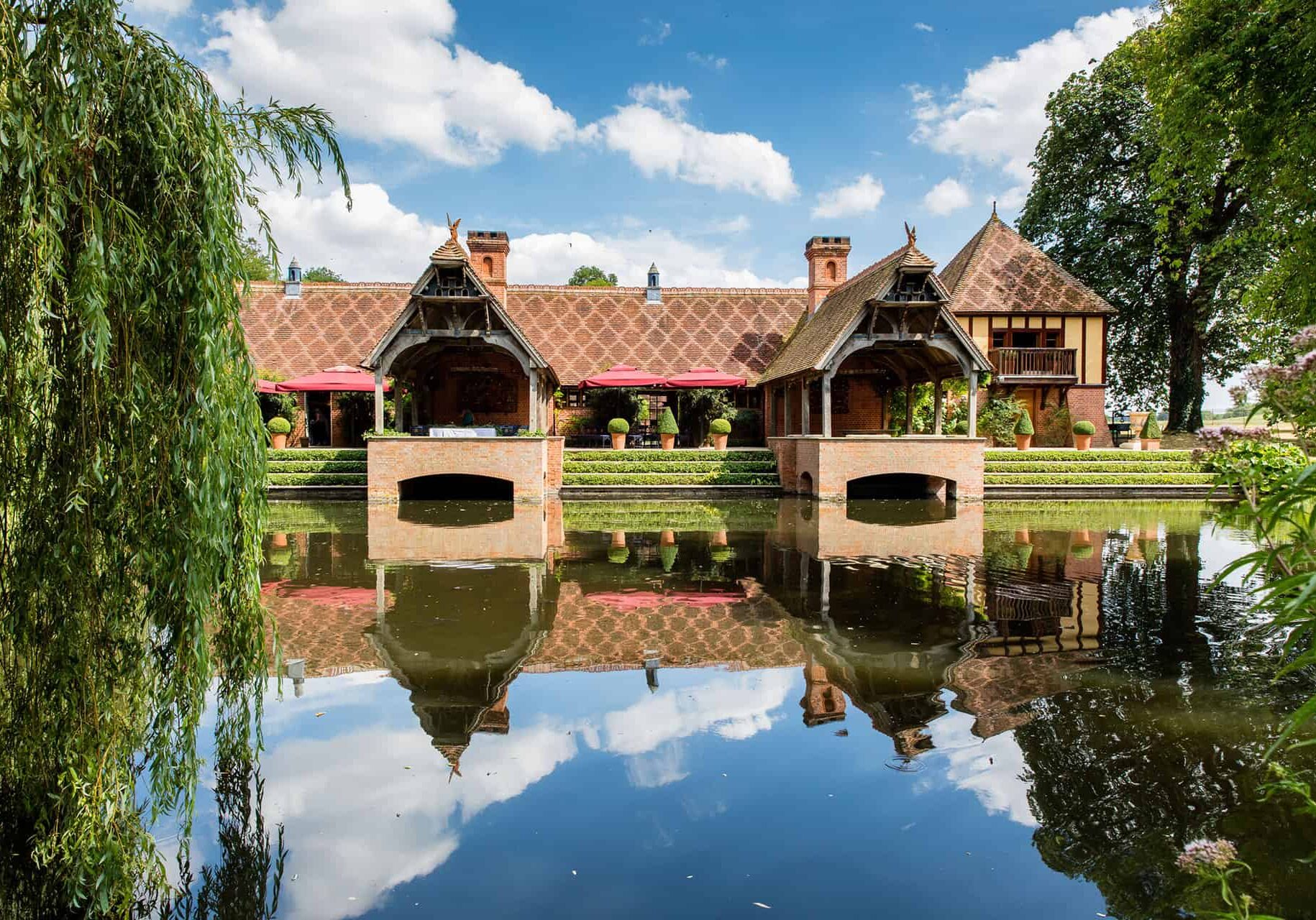 The Dairy at Waddesdon Manor wedding venue reflected in the ornamental moat — wedding venue success